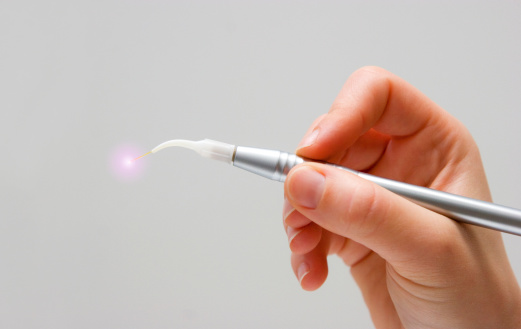 Hand holding a laser dentistry device