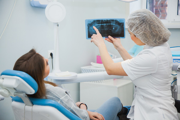 A woman reviewing her xray with a dentist at Michael Yokoyama, D.D.S in Encinitas, CA