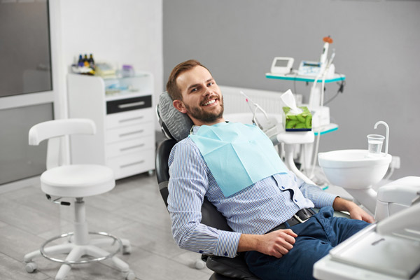Beared man smiling in the dental chair at Encinitas Periodontics & Dental Implants in Encinitas, CA